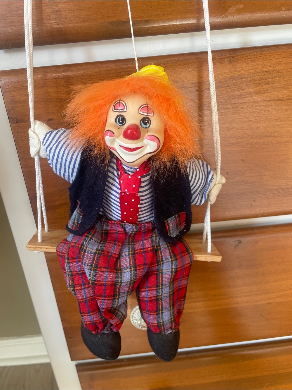 Ceramic Clown sitting on swing with Orange Hair and Red Plaid Pants vintage
